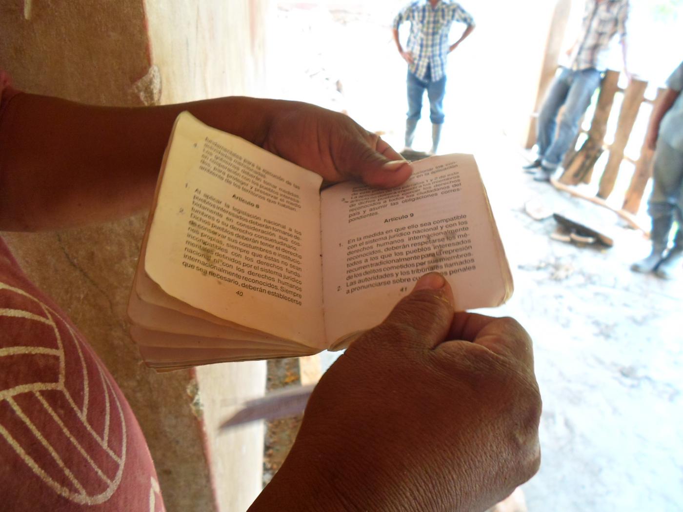 An Indigenous community leader displays the fundamental the rights of indigenous people from the international ILO convention 169. 